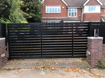 Iron entry gates in black outside somebody's home