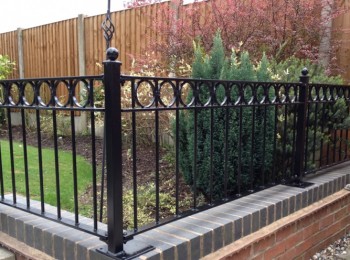 Black Wrought iron fence on a wall